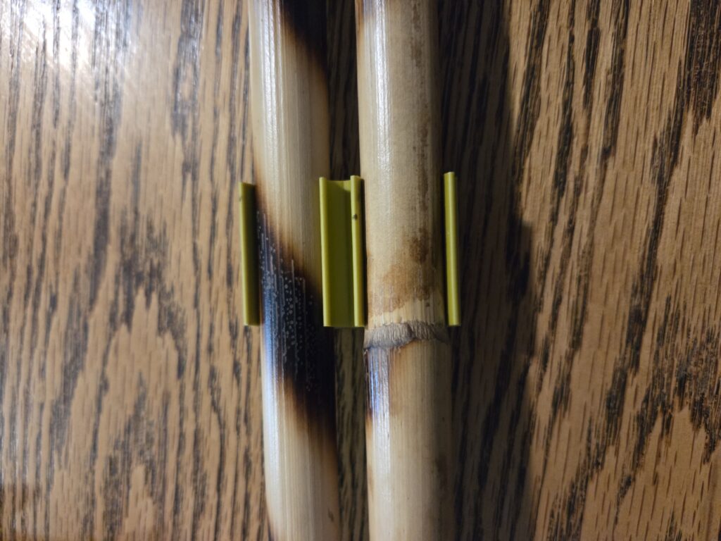 The stick clip will hold two sticks which are around a 1 inch diameter.
